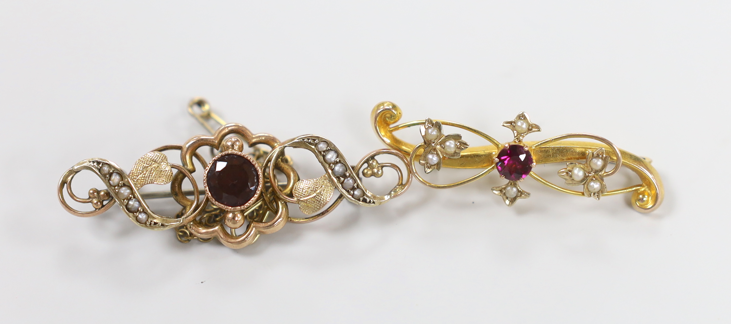 Two early 20th century 9ct and gem set brooches, largest 45mm, gross weight 5.3 grams.